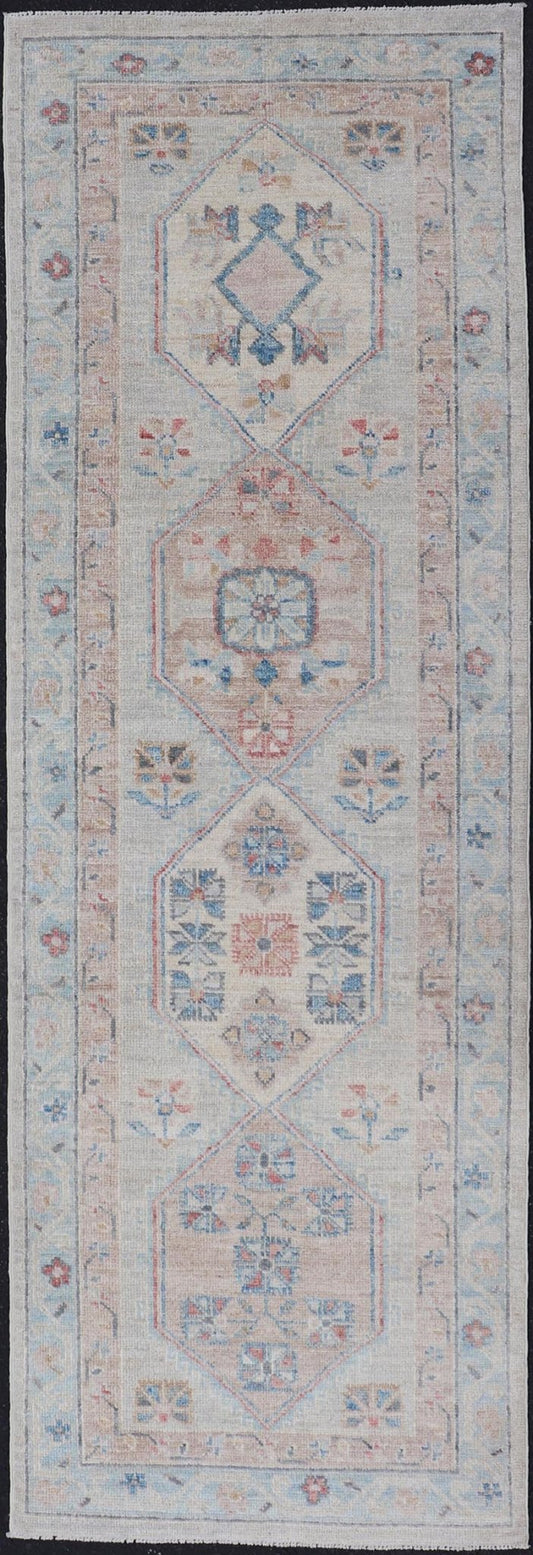 Hand - Knotted Oushak Runner with Medallion Design On A Cream Field With Blues This modern piece holds large medallions in the field, each of which are encasing floral - like motifs. The border is rendered in light blue and coral both embroidere... - Keivan Woven ArtsAWR - 6036 - 19977