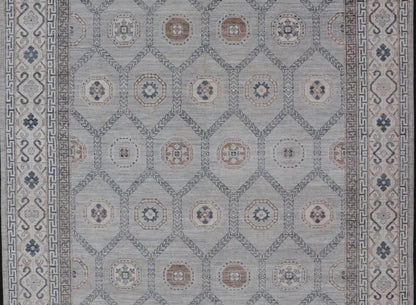 Sub - Geometric Mosaic Khotan Rug With Muted Tones of Blue and Brown This hand - knotted Khotan features geometric medallions, each of which hold a small geometric motif. The border hosts different geometric designs on each tier, alternating between... - Keivan Woven ArtsAWR - 6044 - 19989Rug