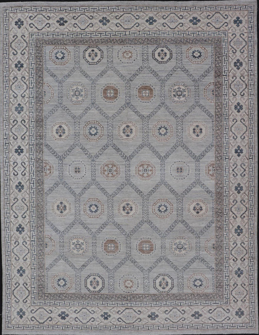 Sub - Geometric Mosaic Khotan Rug With Muted Tones of Blue and Brown This hand - knotted Khotan features geometric medallions, each of which hold a small geometric motif. The border hosts different geometric designs on each tier, alternating between... - Keivan Woven ArtsAWR - 6044 - 19989Rug