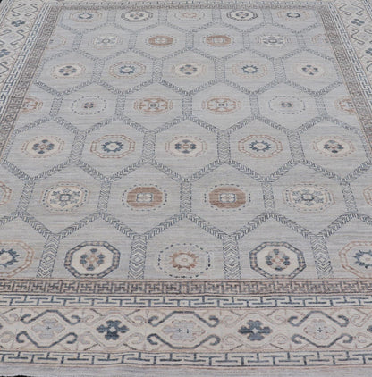 Sub - Geometric Mosaic Khotan Rug With Muted Tones of Blue and Brown This hand - knotted Khotan features geometric medallions, each of which hold a small geometric motif. The border hosts different geometric designs on each tier, alternating between... - Keivan Woven ArtsAWR - 6044 - 19989Rug