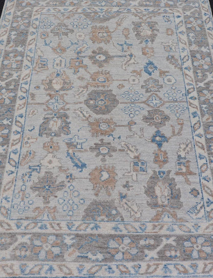 Hand - Knotted All - Over Floral Modern Oushak With Light Brown Border This beautiful contemporary piece starts with a floral border. The field has a modest silvery background with an all - over design rendered with earthy tones, such as wood brown, t... - Keivan Woven ArtsAWR - 6060 - 20001Rug
