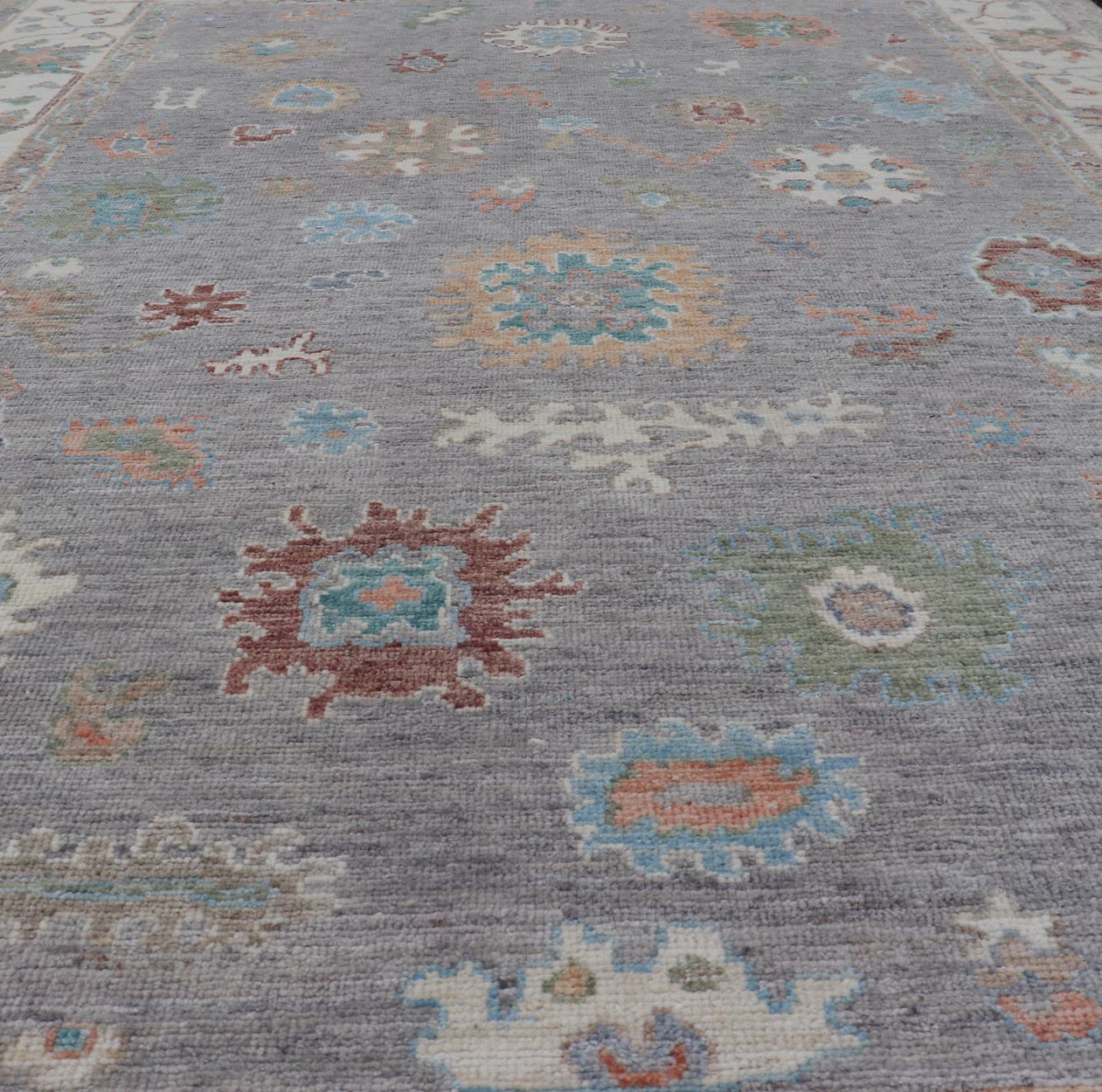 Hand Knotted Floral Oushak With a Gray Background and Multi - Colors This modern casual floral Oushak designed rug has been hand - knotted in wool. The rug features a modern sub - geometric floral design which is enclosed within a complementary, doubl... - Keivan Woven ArtsAWR - 6107 - 20007Rug