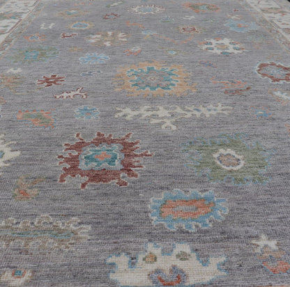Hand Knotted Floral Oushak With a Gray Background and Multi - Colors This modern casual floral Oushak designed rug has been hand - knotted in wool. The rug features a modern sub - geometric floral design which is enclosed within a complementary, doubl... - Keivan Woven ArtsAWR - 6107 - 20007Rug