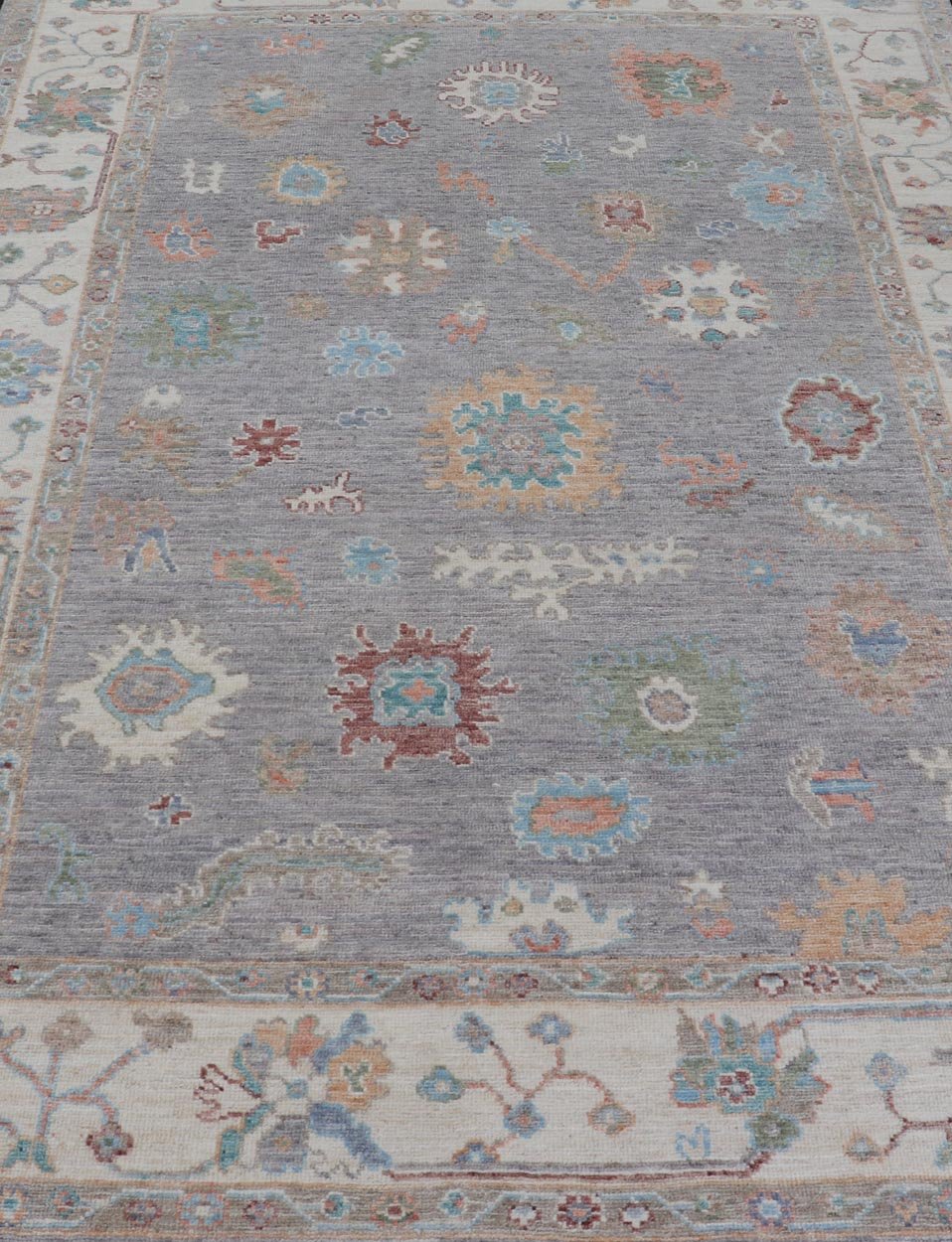 Hand Knotted Floral Oushak With a Gray Background and Multi - Colors This modern casual floral Oushak designed rug has been hand - knotted in wool. The rug features a modern sub - geometric floral design which is enclosed within a complementary, doubl... - Keivan Woven ArtsAWR - 6107 - 20007Rug