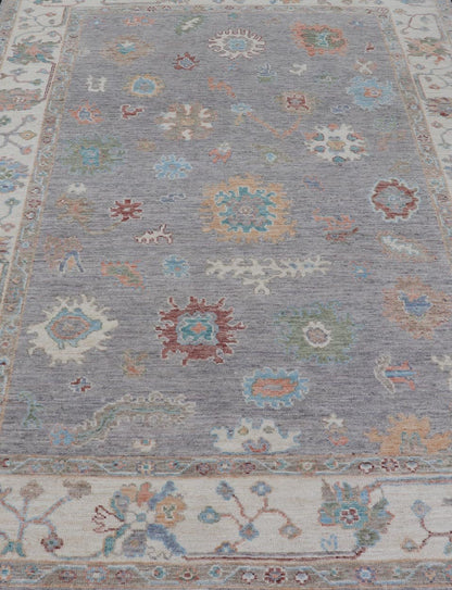 Hand Knotted Floral Oushak With a Gray Background and Multi - Colors This modern casual floral Oushak designed rug has been hand - knotted in wool. The rug features a modern sub - geometric floral design which is enclosed within a complementary, doubl... - Keivan Woven ArtsAWR - 6107 - 20007Rug