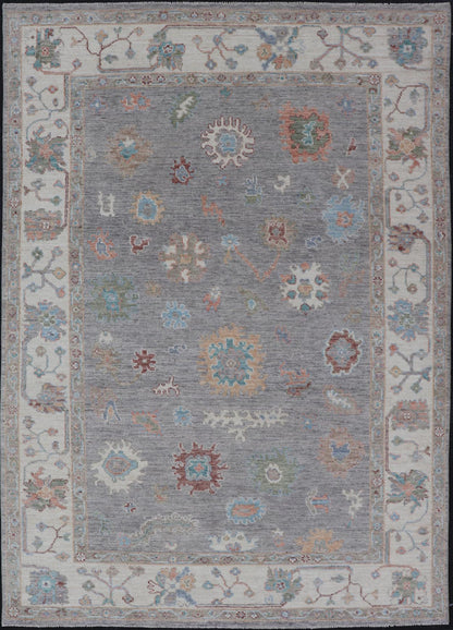 Hand Knotted Floral Oushak With a Gray Background and Multi - Colors This modern casual floral Oushak designed rug has been hand - knotted in wool. The rug features a modern sub - geometric floral design which is enclosed within a complementary, doubl... - Keivan Woven ArtsAWR - 6107 - 20007Rug