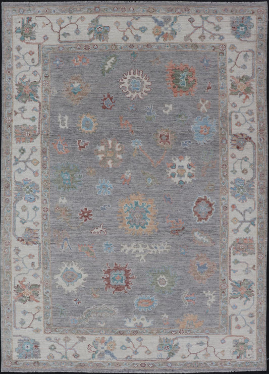 Hand Knotted Floral Oushak With a Gray Background and Multi - Colors This modern casual floral Oushak designed rug has been hand - knotted in wool. The rug features a modern sub - geometric floral design which is enclosed within a complementary, doubl... - Keivan Woven ArtsAWR - 6107 - 20007Rug