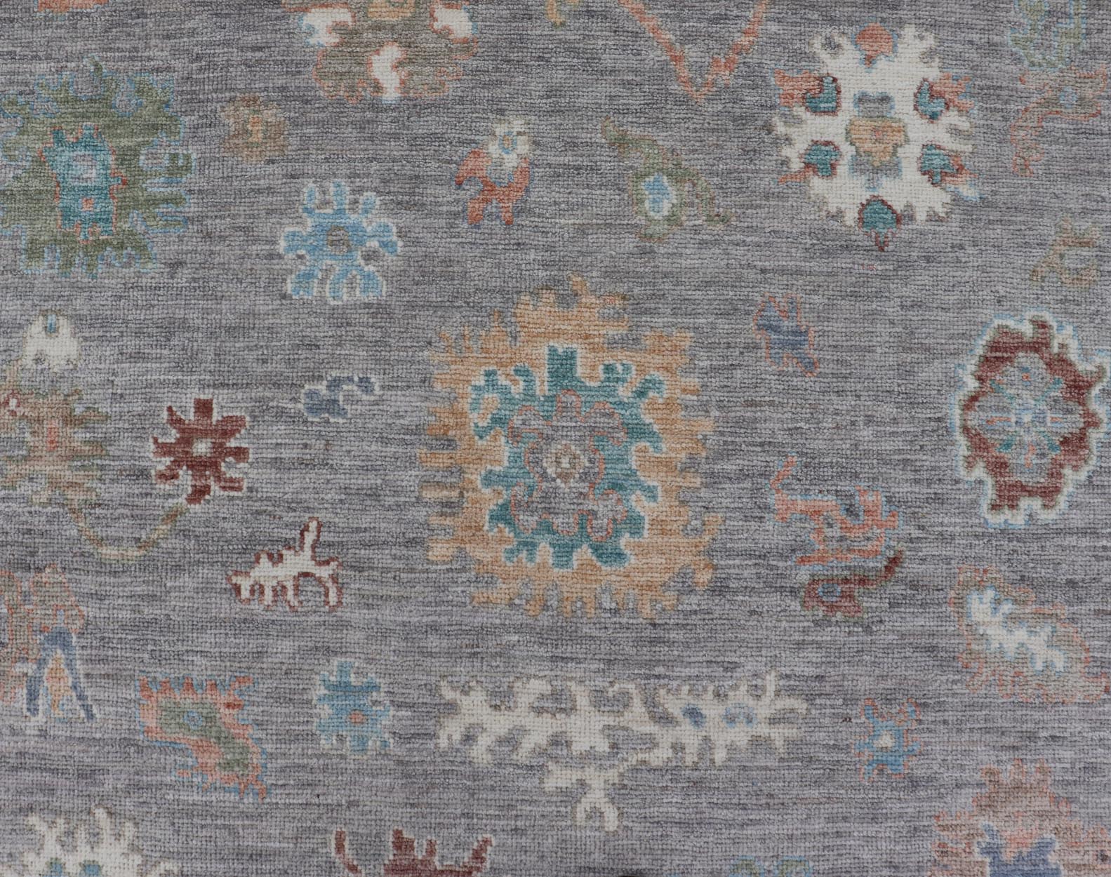 Hand Knotted Floral Oushak With a Gray Background and Multi - Colors This modern casual floral Oushak designed rug has been hand - knotted in wool. The rug features a modern sub - geometric floral design which is enclosed within a complementary, doubl... - Keivan Woven ArtsAWR - 6107 - 20007Rug