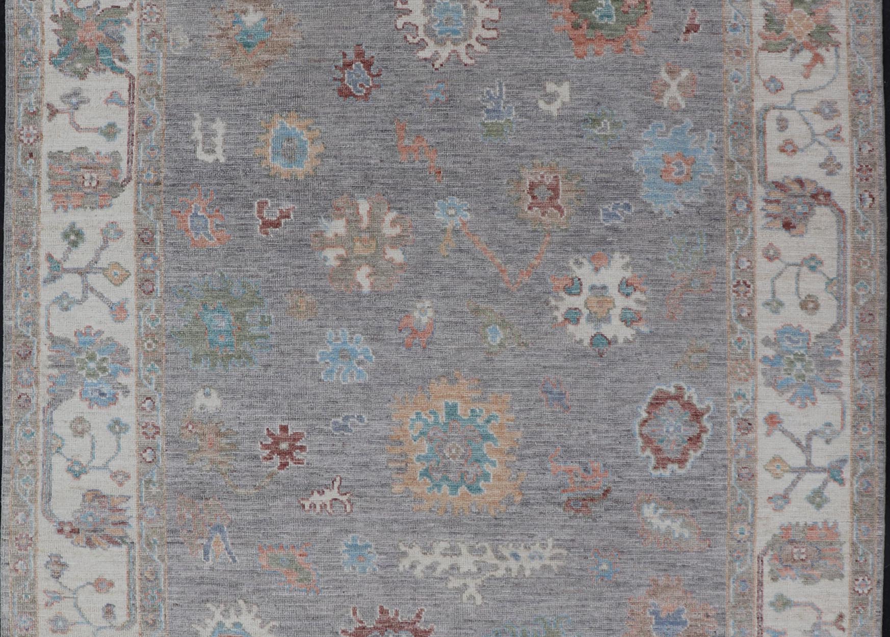 Hand Knotted Floral Oushak With a Gray Background and Multi - Colors This modern casual floral Oushak designed rug has been hand - knotted in wool. The rug features a modern sub - geometric floral design which is enclosed within a complementary, doubl... - Keivan Woven ArtsAWR - 6107 - 20007Rug