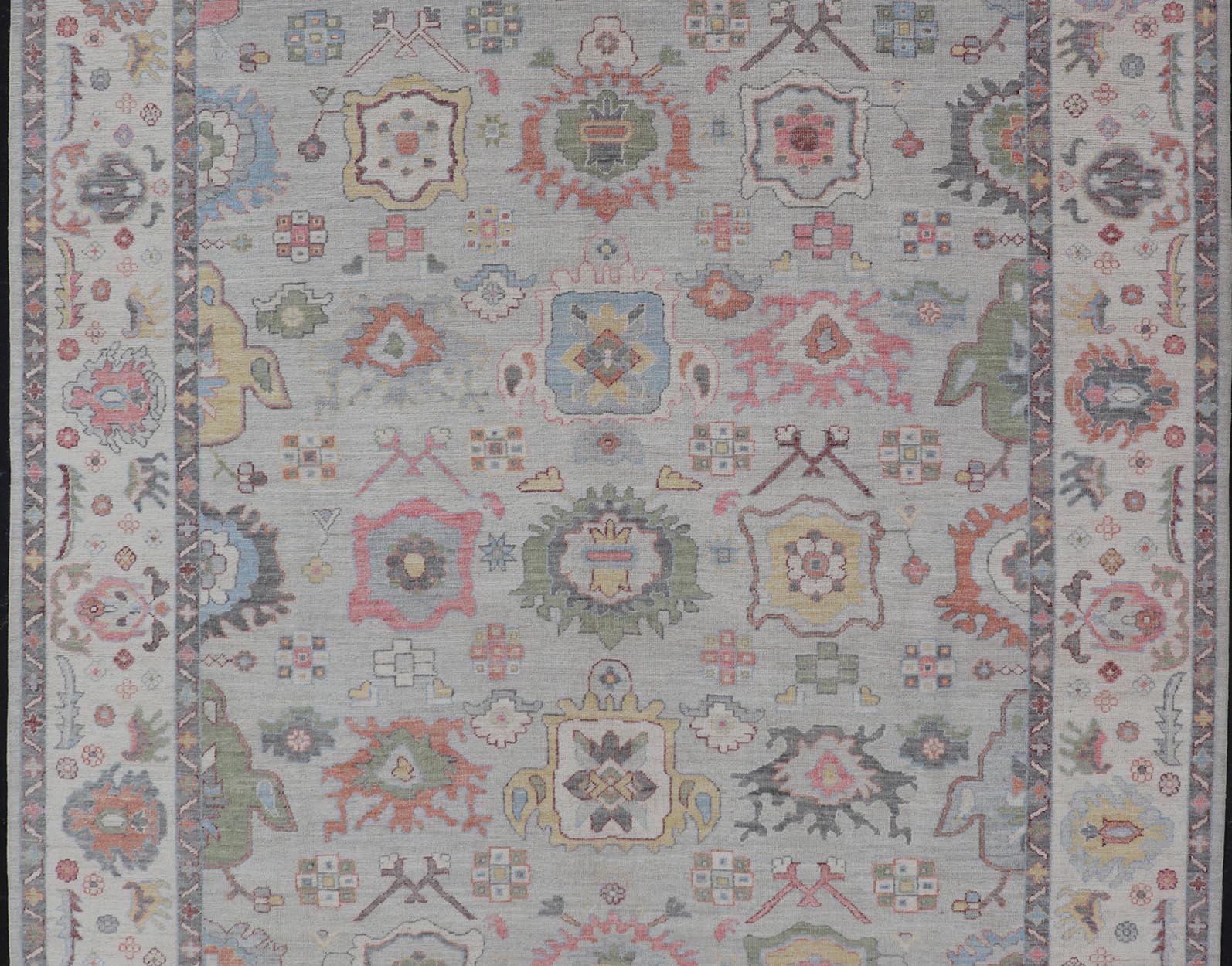 Oushak Floral Motif on Light Grey Background and Colorful Design The border and field are covered in floral - like motifs filled with colors such as pink, green, gold, teal and red - oranges on top of silvery grey background. The border showcases a ... - Keivan Woven ArtsAWR - 6148 - 20025Rug