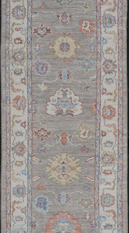 Hand - Knotted Modern Oushak Runner on Light Gray Field and Colorful Motifs This Oushak runner has been hand - knotted. The arabesque motifs scatter atop a light gray background. Within the field, bright displays of gold, teal, blue, pink, maroon, ... - Keivan Woven ArtsAWR - 6196 - 19899Rug