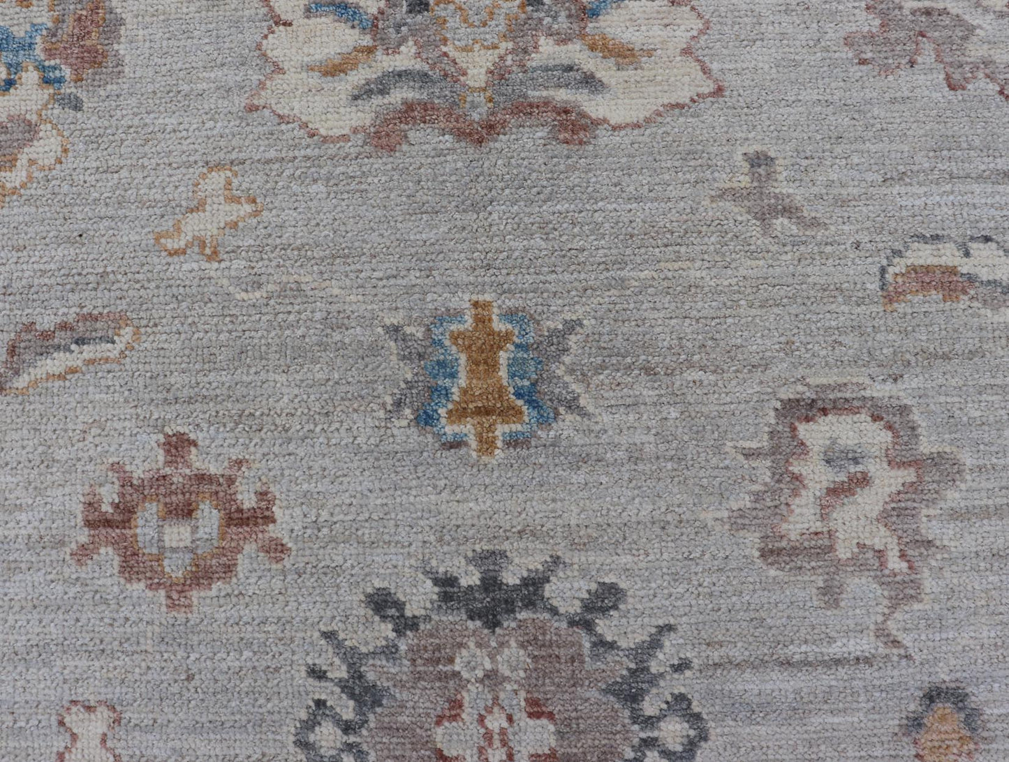 Floral Modern Oushak With Muted Gray Background and Cream Border This piece gives a modern vibrancy to the classic floral Oushak design. With a louder light gray background, the field showcases bold accents of cream and taupe in a half - floral, ... - Keivan Woven ArtsAWR - 6287 - 20031Rug