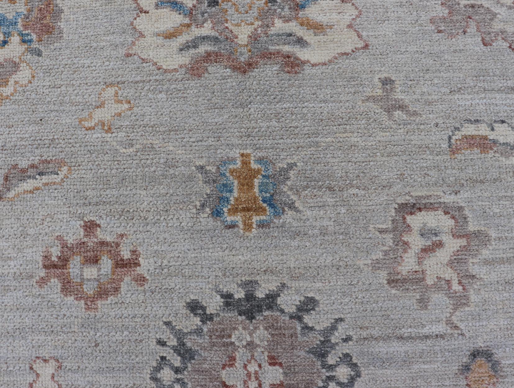 Floral Modern Oushak With Muted Gray Background and Cream Border This piece gives a modern vibrancy to the classic floral Oushak design. With a louder light gray background, the field showcases bold accents of cream and taupe in a half - floral, ... - Keivan Woven ArtsAWR - 6287 - 20031Rug