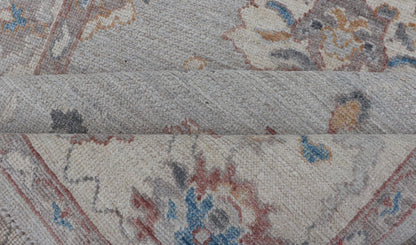 Floral Modern Oushak With Muted Gray Background and Cream Border This piece gives a modern vibrancy to the classic floral Oushak design. With a louder light gray background, the field showcases bold accents of cream and taupe in a half - floral, ... - Keivan Woven ArtsAWR - 6287 - 20031Rug