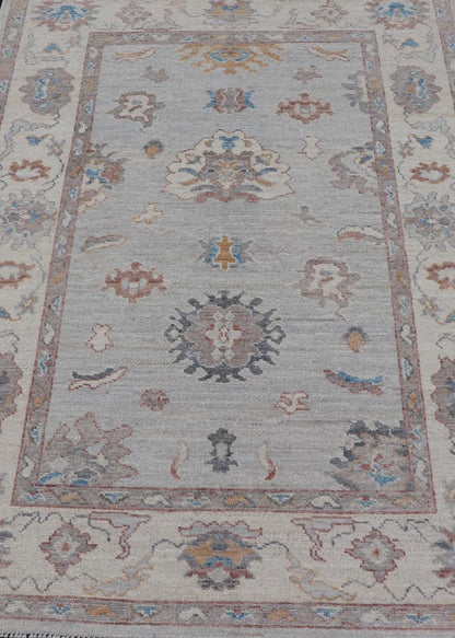 Floral Modern Oushak With Muted Gray Background and Cream Border This piece gives a modern vibrancy to the classic floral Oushak design. With a louder light gray background, the field showcases bold accents of cream and taupe in a half - floral, ... - Keivan Woven ArtsAWR - 6287 - 20031Rug