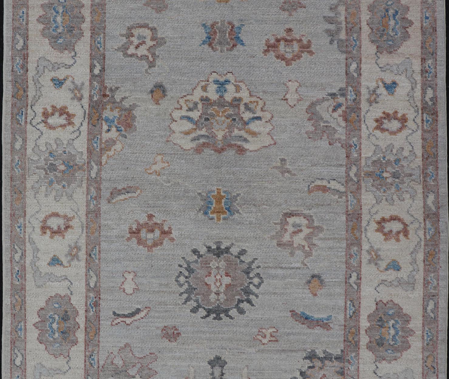 Floral Modern Oushak With Muted Gray Background and Cream Border This piece gives a modern vibrancy to the classic floral Oushak design. With a louder light gray background, the field showcases bold accents of cream and taupe in a half - floral, ... - Keivan Woven ArtsAWR - 6287 - 20031Rug