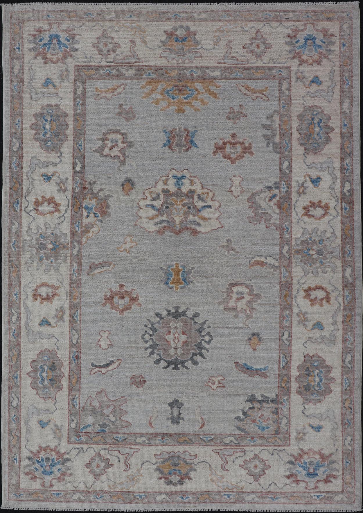 Floral Modern Oushak With Muted Gray Background and Cream Border This piece gives a modern vibrancy to the classic floral Oushak design. With a louder light gray background, the field showcases bold accents of cream and taupe in a half - floral, ... - Keivan Woven ArtsAWR - 6287 - 20031Rug
