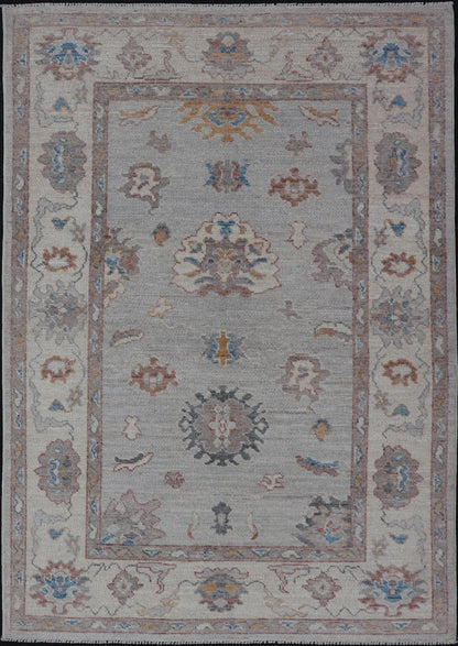 Floral Modern Oushak With Muted Gray Background and Cream Border This piece gives a modern vibrancy to the classic floral Oushak design. With a louder light gray background, the field showcases bold accents of cream and taupe in a half - floral, ... - Keivan Woven ArtsAWR - 6287 - 20031Rug