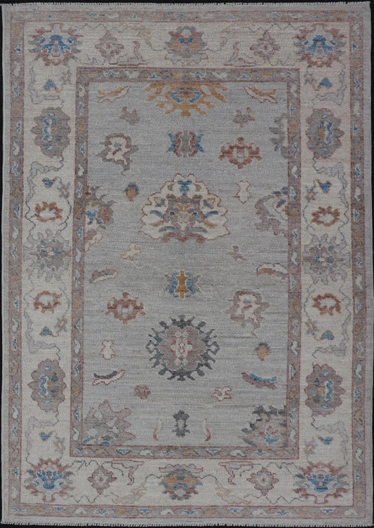 Floral Modern Oushak With Muted Gray Background and Cream Border This piece gives a modern vibrancy to the classic floral Oushak design. With a louder light gray background, the field showcases bold accents of cream and taupe in a half - floral, ... - Keivan Woven ArtsAWR - 6287 - 20031Rug