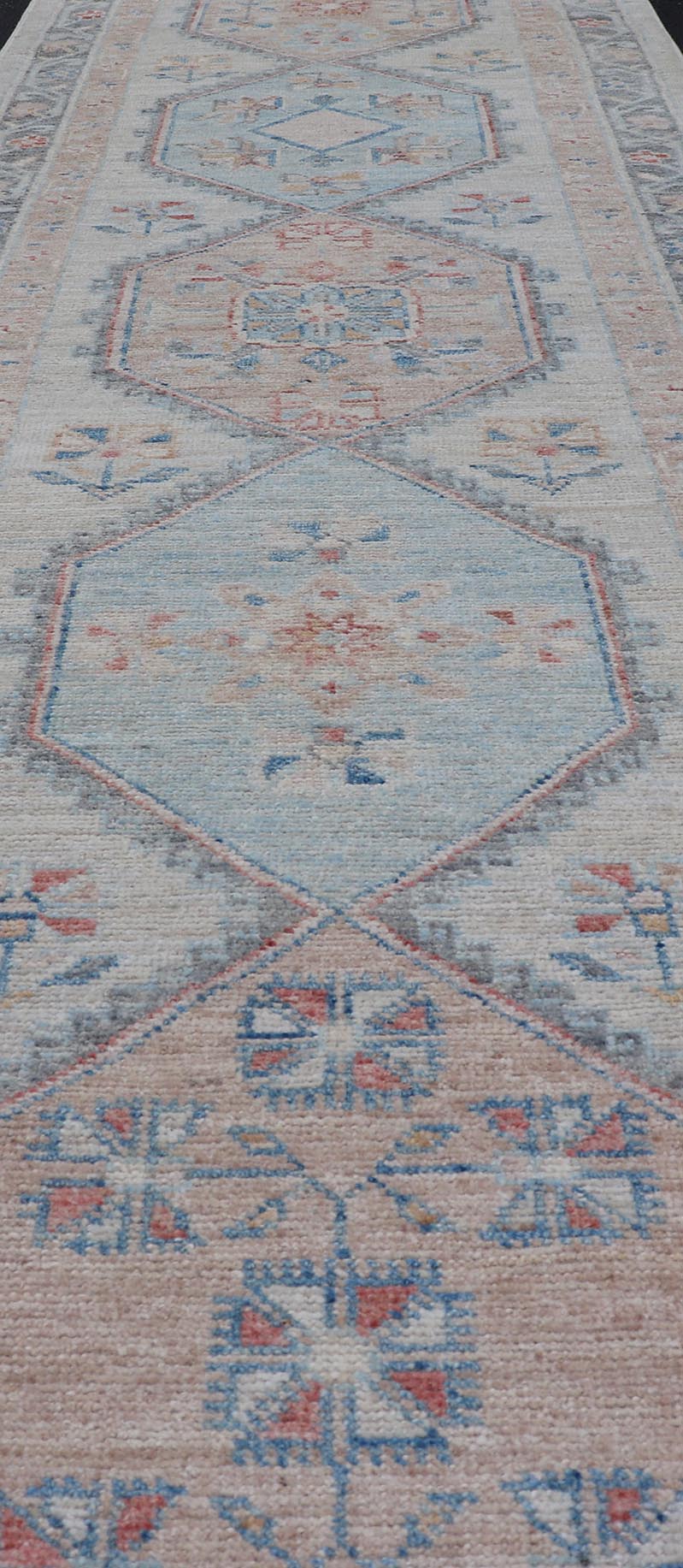 Modern Oushak Medallion Runner in Pastel Color Tones This Afghan Oushak presents a double - lined floral border on top of a light gray background, accenting colors such as blue, red, and salmon. These mix of tones gives a great contrast to many in... - Keivan Woven ArtsAWR - 6290 - 20037Rug