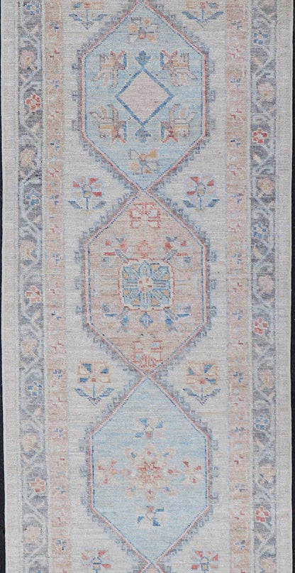 Modern Oushak Medallion Runner in Pastel Color Tones This Afghan Oushak presents a double - lined floral border on top of a light gray background, accenting colors such as blue, red, and salmon. These mix of tones gives a great contrast to many in... - Keivan Woven ArtsAWR - 6290 - 20037Rug