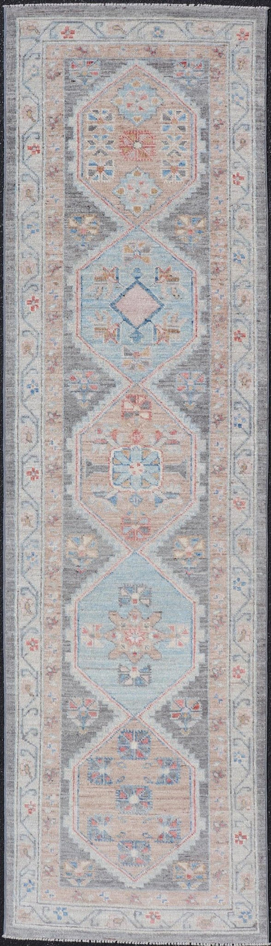 Floral Medallion Oushak Runner With Tribal Motifs and On A Gray Background This Hand - Knotted Afghan Oushak presents a double - lined floral border on top of a dark taupe background, accenting colors such as blue, red, and peach. The field disp... - Keivan Woven ArtsAWR - 6296 - 19905Rug