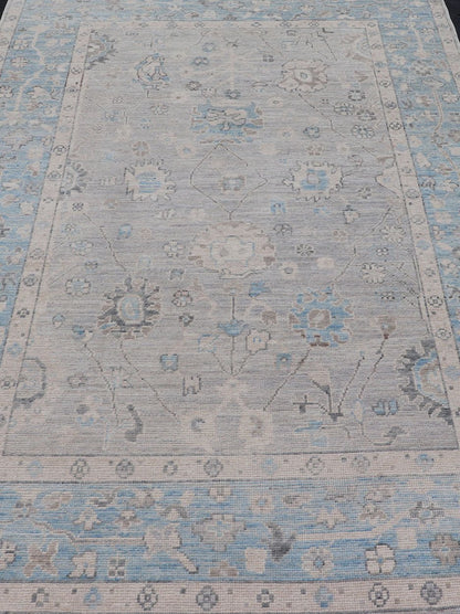 Hand - Knotted Light Blue Oushak with Light Gray Background Hand - Knotted in Afghanistan, this rustic piece holds charm within a powder blue border and a light gray field background. Above lays a modest Oushak - styled floral design reaching all ... - Keivan Woven ArtsAWR - 6309 - 20049Rug