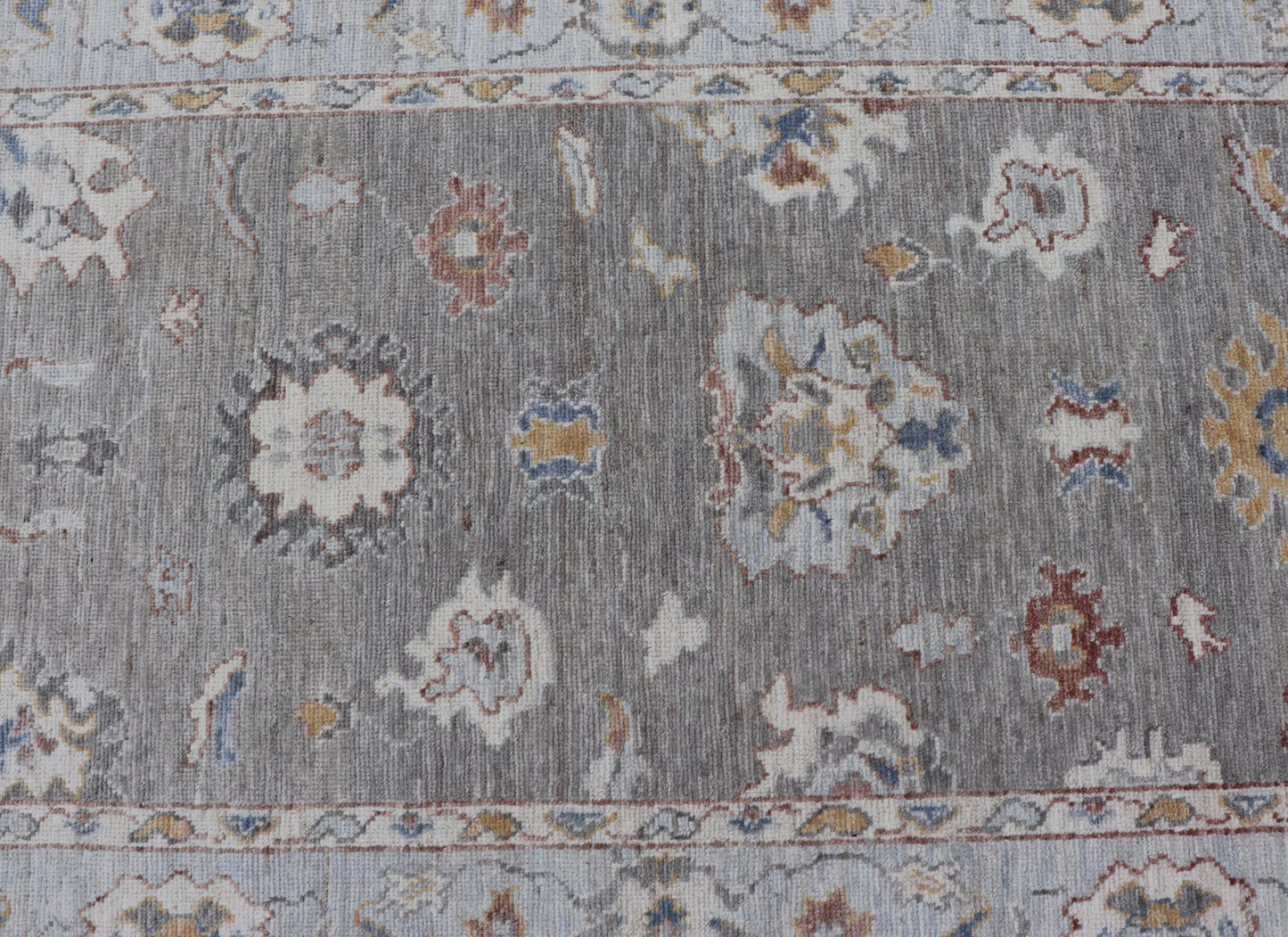 Modern Hand Knotted Oushak with Muted Background and Earthy Accents This beautiful rug starts in a light gray background, paired with a steel blue in the border. The design is an all - over Oushak floral design, highlighting unique colors, su... - Keivan Woven ArtsAWR - 6320 - 20055Rug