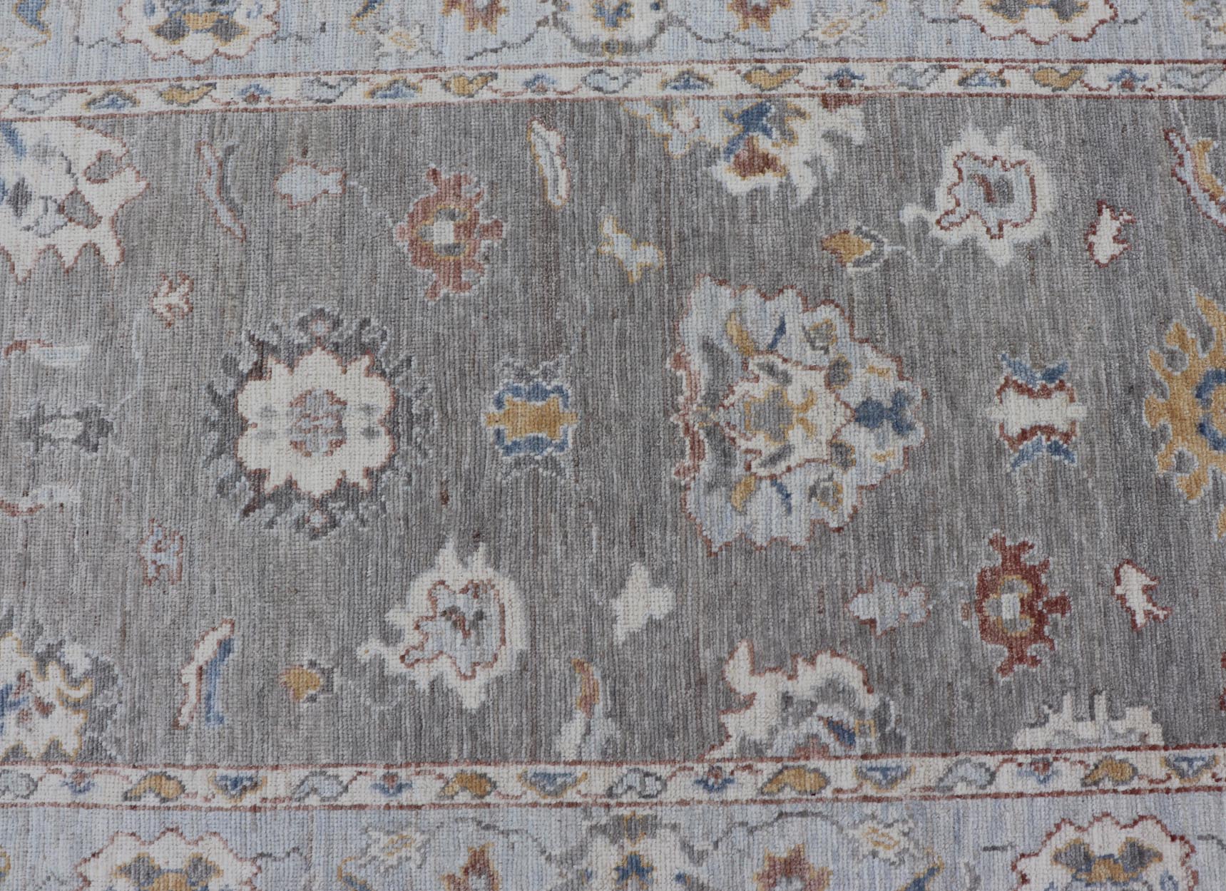 Modern Hand Knotted Oushak with Muted Background and Earthy Accents This beautiful rug starts in a light gray background, paired with a steel blue in the border. The design is an all - over Oushak floral design, highlighting unique colors, su... - Keivan Woven ArtsAWR - 6320 - 20055Rug
