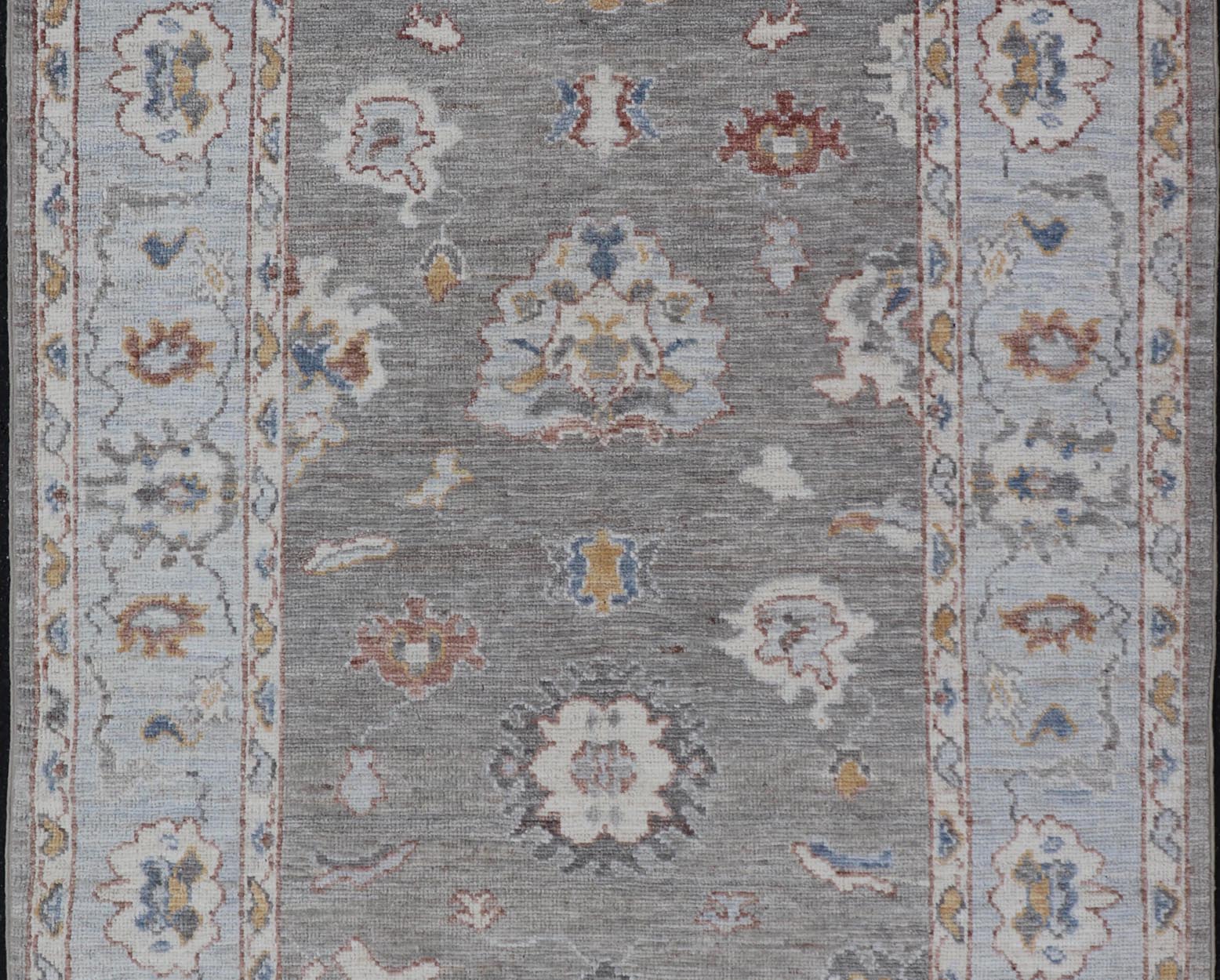 Modern Hand Knotted Oushak with Muted Background and Earthy Accents This beautiful rug starts in a light gray background, paired with a steel blue in the border. The design is an all - over Oushak floral design, highlighting unique colors, su... - Keivan Woven ArtsAWR - 6320 - 20055Rug