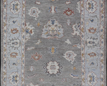 Modern Hand Knotted Oushak with Muted Background and Earthy Accents This beautiful rug starts in a light gray background, paired with a steel blue in the border. The design is an all - over Oushak floral design, highlighting unique colors, su... - Keivan Woven ArtsAWR - 6320 - 20055Rug