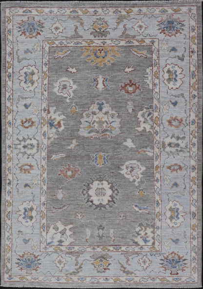 Modern Hand Knotted Oushak with Muted Background and Earthy Accents This beautiful rug starts in a light gray background, paired with a steel blue in the border. The design is an all - over Oushak floral design, highlighting unique colors, su... - Keivan Woven ArtsAWR - 6320 - 20055Rug