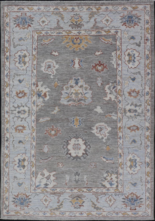 Modern Hand Knotted Oushak with Muted Background and Earthy Accents This beautiful rug starts in a light gray background, paired with a steel blue in the border. The design is an all - over Oushak floral design, highlighting unique colors, su... - Keivan Woven ArtsAWR - 6320 - 20055Rug
