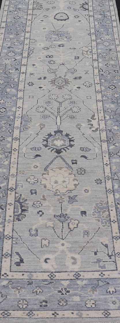 Modern Oushak Design With Light Blue Background and All - Over Design This Afghan runner features a classic Oushak look, showing off brilliant floral motifs and vines reaching all over the field against a cool gray and pewter background. Central ... - Keivan Woven ArtsAWR - 6325 - 20061Rug