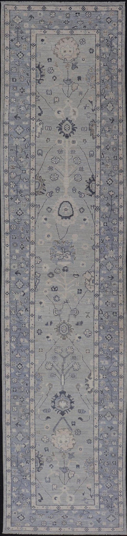 Modern Oushak Design With Light Blue Background and All - Over Design This Afghan runner features a classic Oushak look, showing off brilliant floral motifs and vines reaching all over the field against a cool gray and pewter background. Central ... - Keivan Woven ArtsAWR - 6325 - 20061Rug