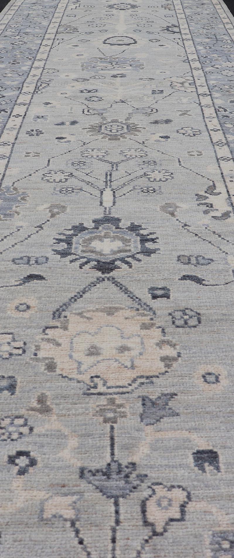 Modern Oushak Design With Light Blue Background and All - Over Design This Afghan runner features a classic Oushak look, showing off brilliant floral motifs and vines reaching all over the field against a cool gray and pewter background. Central ... - Keivan Woven ArtsAWR - 6325 - 20061Rug