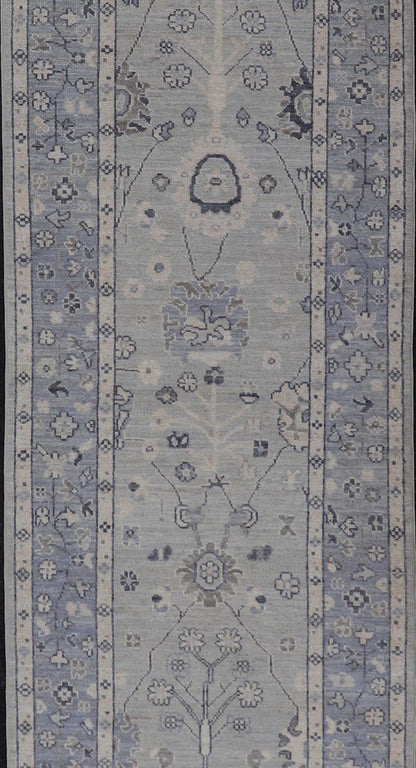 Modern Oushak Design With Light Blue Background and All - Over Design This Afghan runner features a classic Oushak look, showing off brilliant floral motifs and vines reaching all over the field against a cool gray and pewter background. Central ... - Keivan Woven ArtsAWR - 6325 - 20061Rug