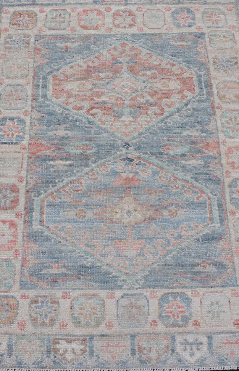 Medallion Designed Modern Oushak with Light Blue Background and Cream Border This modern Oushak features large medallions in the center of a light blue background, centering around shades of blue, coral, and light green. The border features seve... - Keivan Woven ArtsAWR - 6363 - 20073Rug