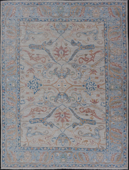 Arabesque All - Over Hand Knotted Oushak in Ivory and Blue Tones The field is backed by a ivory color, with a light blue border, etched with elegant golden/brown branches. The arabesque - like design brings splashes of light blue, cognac, and reddis... - Keivan Woven ArtsAWR - 6407 - 20079Rug