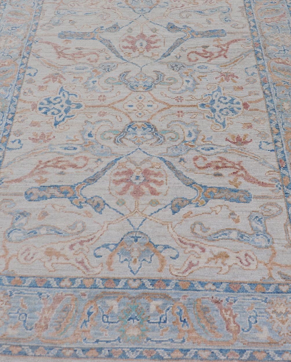 Arabesque All - Over Hand Knotted Oushak in Ivory and Blue Tones The field is backed by a ivory color, with a light blue border, etched with elegant golden/brown branches. The arabesque - like design brings splashes of light blue, cognac, and reddis... - Keivan Woven ArtsAWR - 6407 - 20079Rug