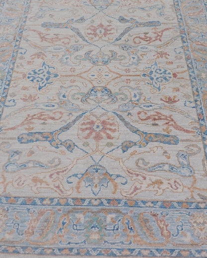 Arabesque All - Over Hand Knotted Oushak in Ivory and Blue Tones The field is backed by a ivory color, with a light blue border, etched with elegant golden/brown branches. The arabesque - like design brings splashes of light blue, cognac, and reddis... - Keivan Woven ArtsAWR - 6407 - 20079Rug