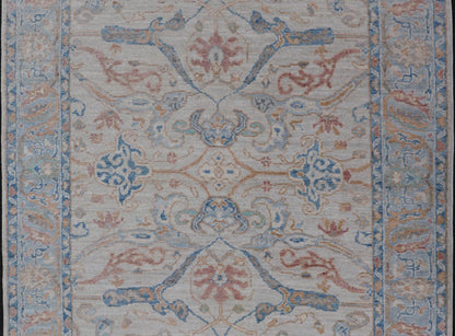 Arabesque All - Over Hand Knotted Oushak in Ivory and Blue Tones The field is backed by a ivory color, with a light blue border, etched with elegant golden/brown branches. The arabesque - like design brings splashes of light blue, cognac, and reddis... - Keivan Woven ArtsAWR - 6407 - 20079Rug