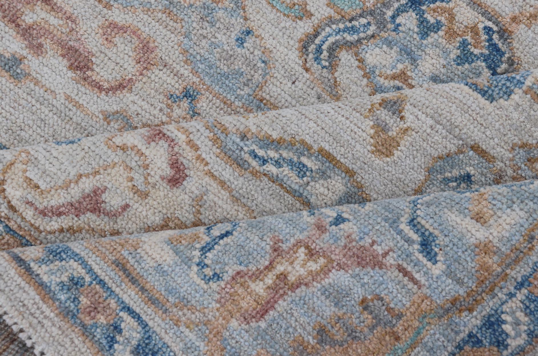 Arabesque All - Over Hand Knotted Oushak in Ivory and Blue Tones The field is backed by a ivory color, with a light blue border, etched with elegant golden/brown branches. The arabesque - like design brings splashes of light blue, cognac, and reddis... - Keivan Woven ArtsAWR - 6407 - 20079Rug