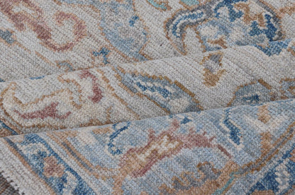 Arabesque All - Over Hand Knotted Oushak in Ivory and Blue Tones The field is backed by a ivory color, with a light blue border, etched with elegant golden/brown branches. The arabesque - like design brings splashes of light blue, cognac, and reddis... - Keivan Woven ArtsAWR - 6407 - 20079Rug