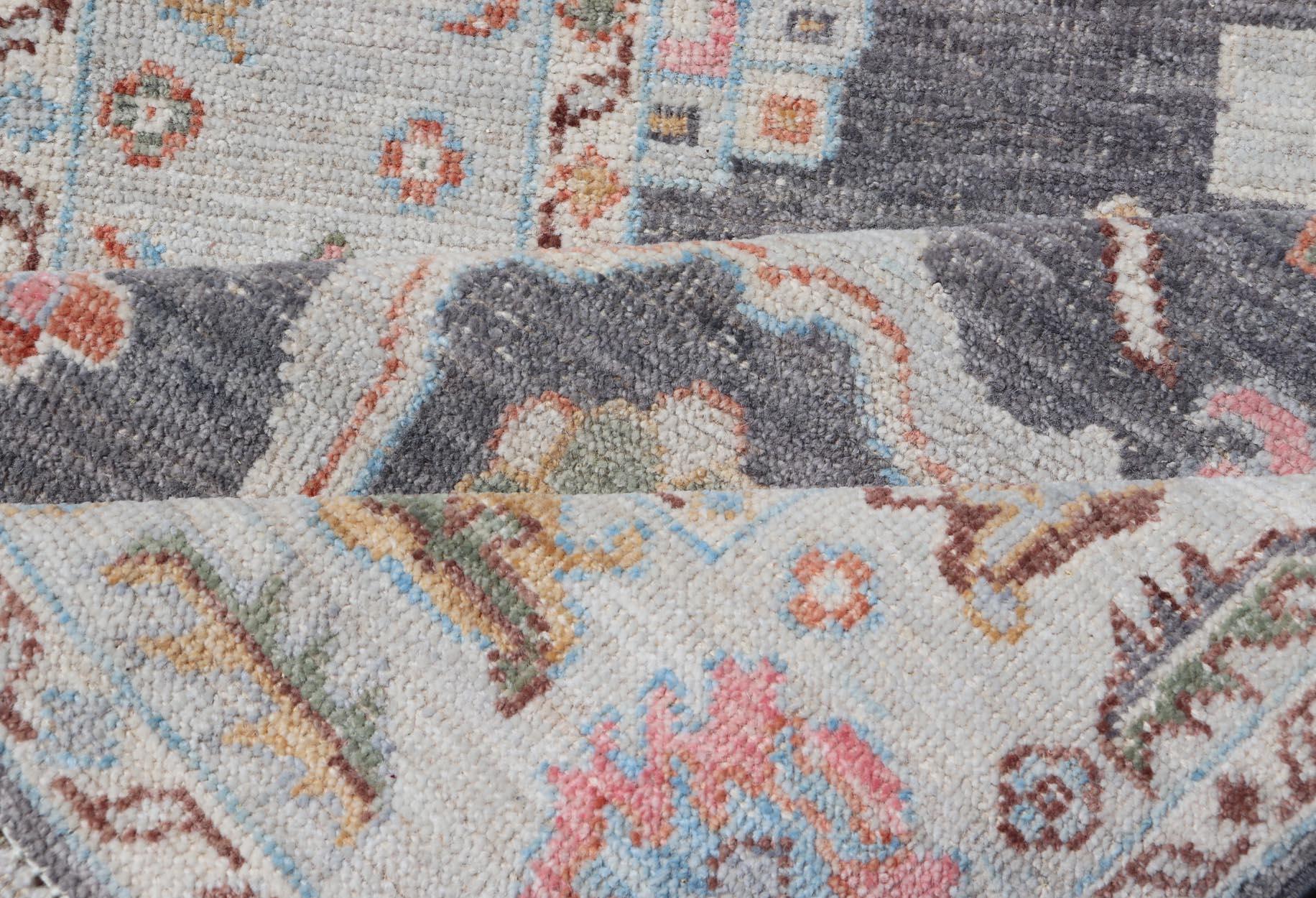 Hand Knotted Afghan Oushak Designed Runner with Gray Background This Afghan Oushak runner features a grand motif, showcasing from the border to the field with a vibrant elegance that pops against the light blue - gray border, as well as the charc... - Keivan Woven ArtsAWR - 6463 - 19911Rug
