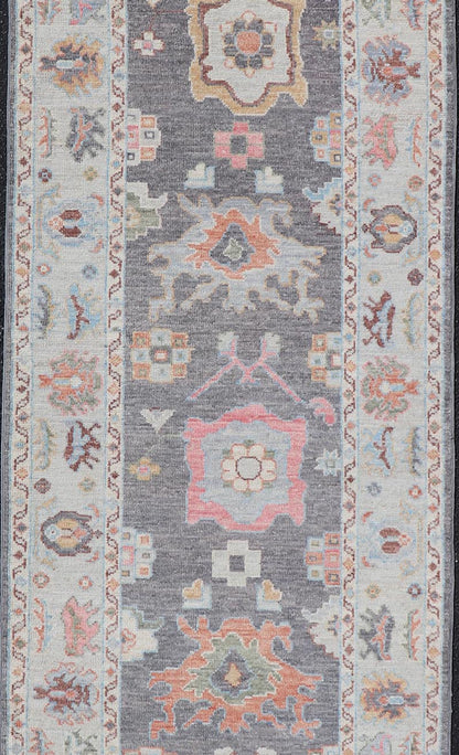 Hand Knotted Afghan Oushak Designed Runner with Gray Background This Afghan Oushak runner features a grand motif, showcasing from the border to the field with a vibrant elegance that pops against the light blue - gray border, as well as the charc... - Keivan Woven ArtsAWR - 6463 - 19911Rug