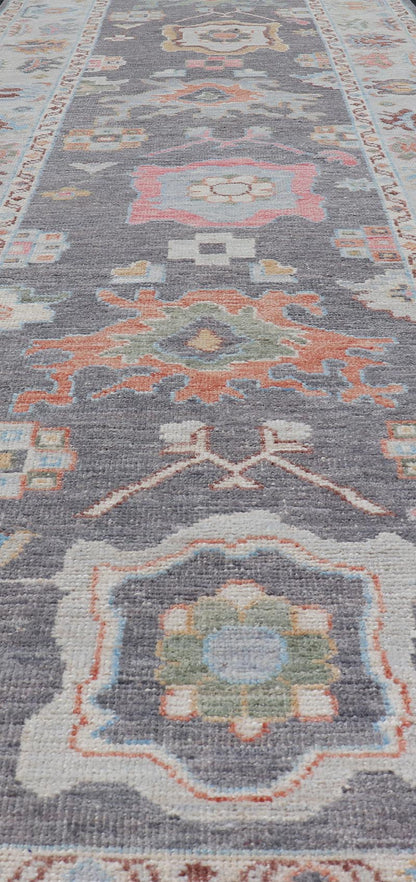 Hand Knotted Afghan Oushak Designed Runner with Gray Background This Afghan Oushak runner features a grand motif, showcasing from the border to the field with a vibrant elegance that pops against the light blue - gray border, as well as the charc... - Keivan Woven ArtsAWR - 6463 - 19911Rug