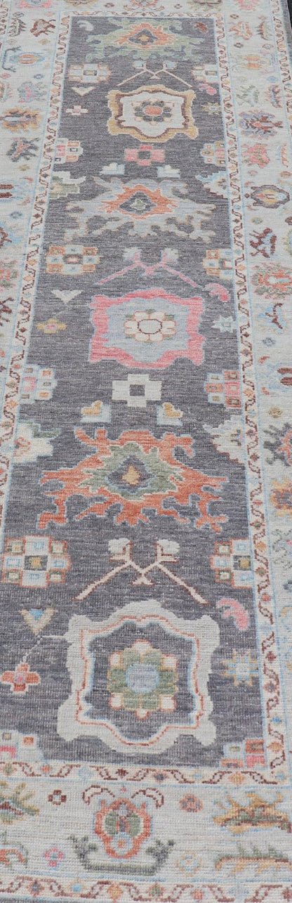 Hand Knotted Afghan Oushak Designed Runner with Gray Background This Afghan Oushak runner features a grand motif, showcasing from the border to the field with a vibrant elegance that pops against the light blue - gray border, as well as the charc... - Keivan Woven ArtsAWR - 6463 - 19911Rug