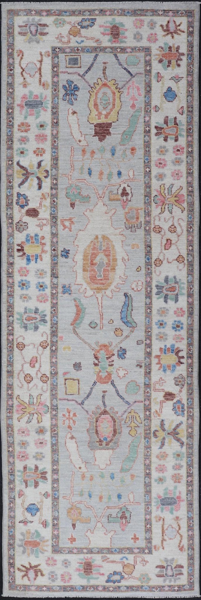 Measures: 3'1 x 10'0 Hand knotted in Afghanistan, this modern oushak runner showcasing the distinct large - scale angular floral design, with a modern bright splash of color against a cool gray background. The monotone cream - to - gray in the backgro... - Keivan Woven ArtsAWR - 6541 - 20085