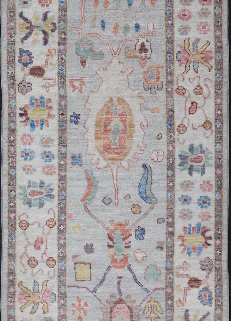 Measures: 3'1 x 10'0 Hand knotted in Afghanistan, this modern oushak runner showcasing the distinct large - scale angular floral design, with a modern bright splash of color against a cool gray background. The monotone cream - to - gray in the backgro... - Keivan Woven ArtsAWR - 6541 - 20085Rug